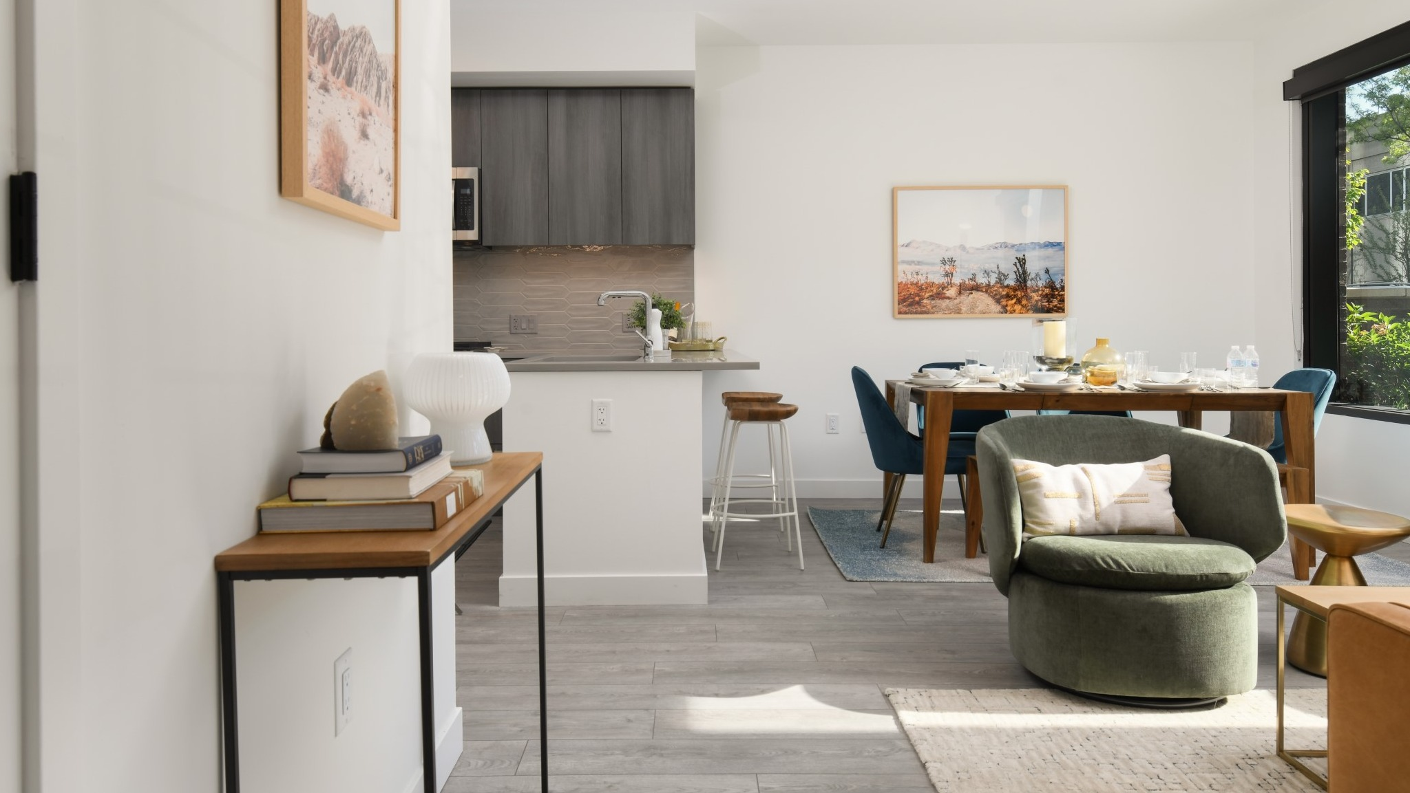 Panoramic view of the dining and living area at Porte Apartments Chicago, showcasing modern design, vibrant art, and ample space