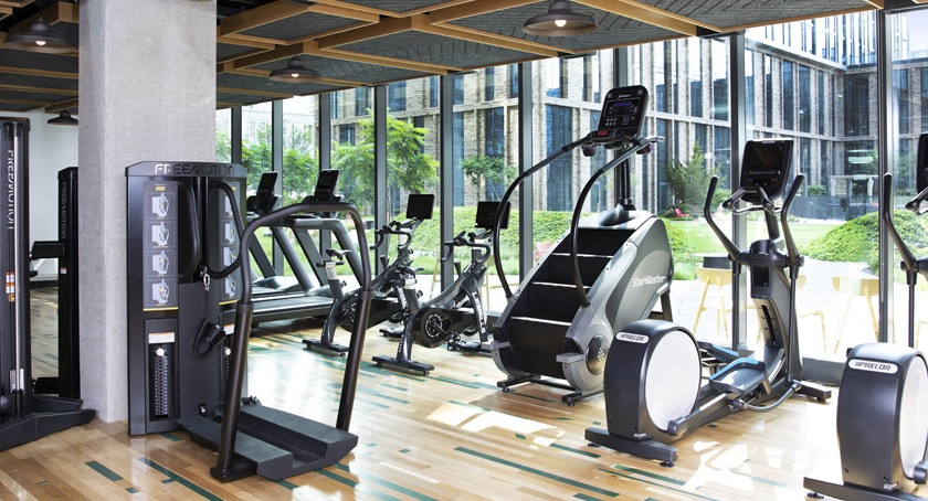 State-of-the-art fitness center at Porte Apartments Chicago, featuring a variety of cardio and strength training equipment in a spacious setting
