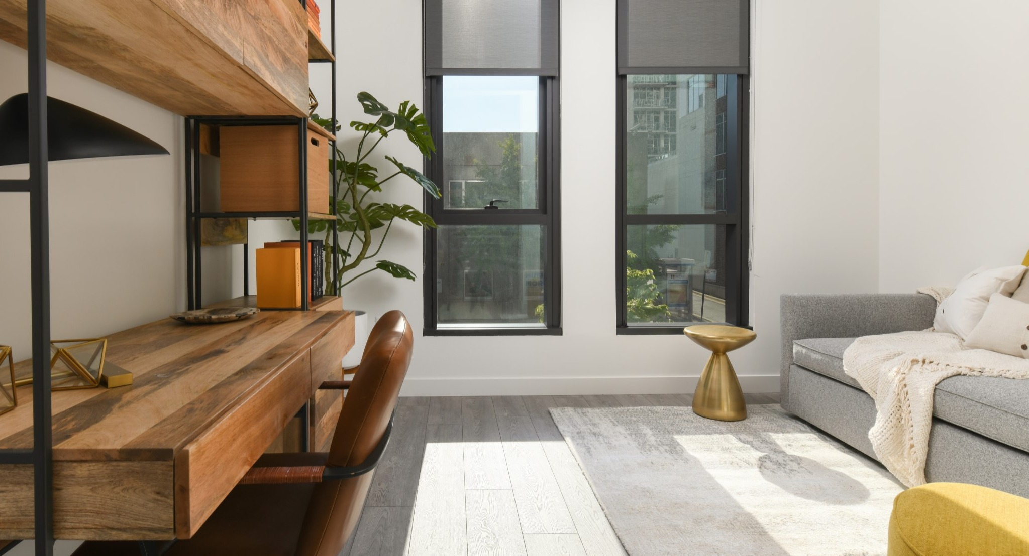 Dedicated home office space at Porte Apartments Chicago, featuring a stylish wooden desk, shelving, and large windows for natural light