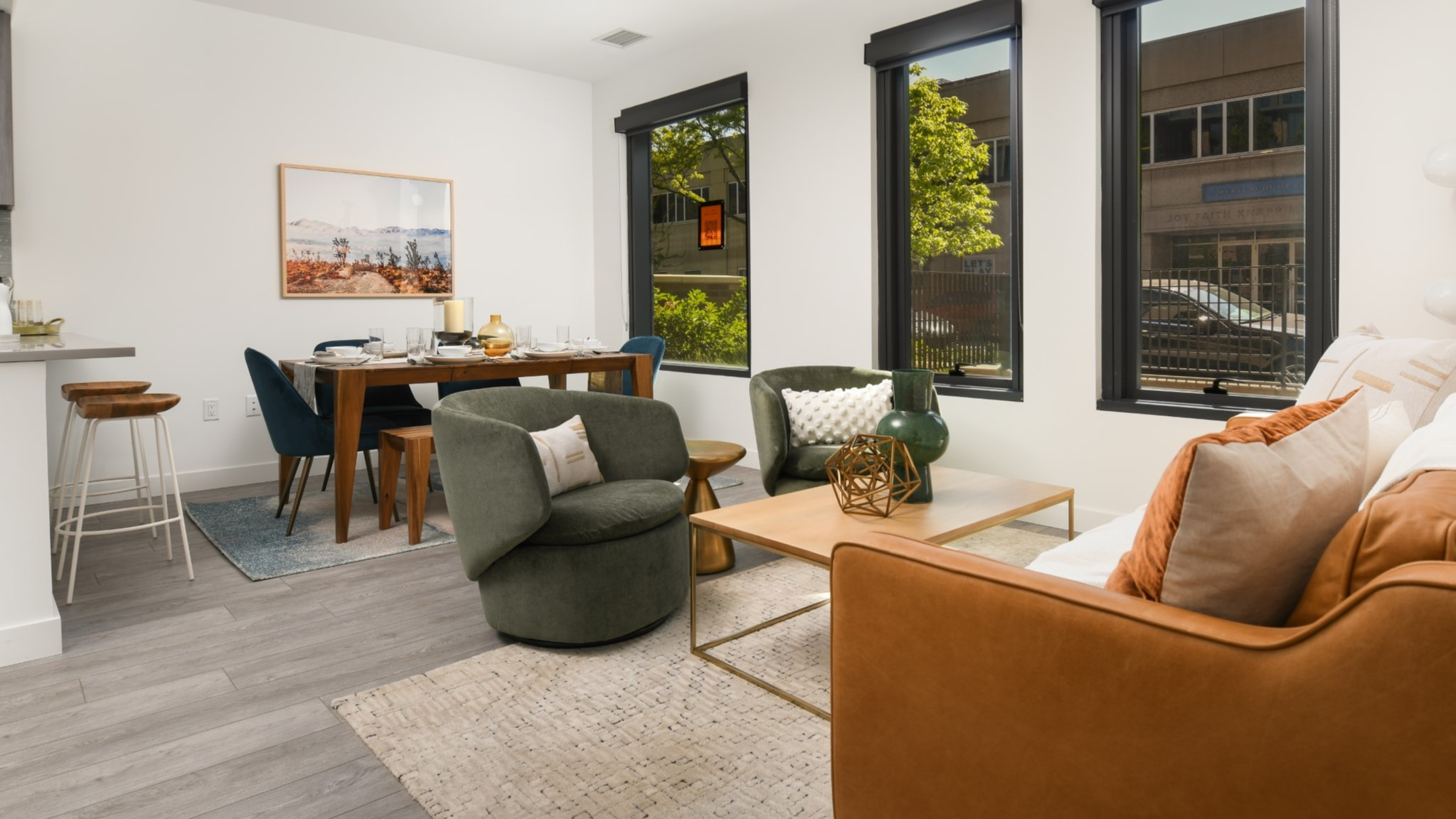 Spacious living and dining area at Porte Apartments Chicago, featuring comfortable seating, a dining table, and large windows