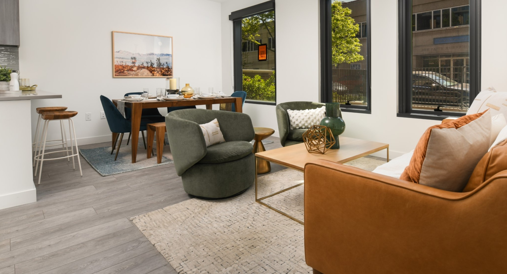 Spacious living and dining area at Porte Apartments Chicago, featuring comfortable seating, a dining table, and large windows
