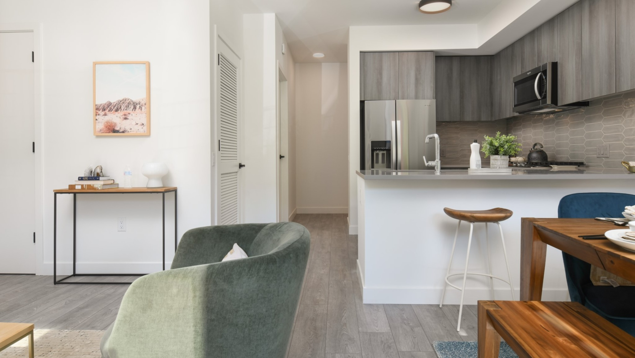 Spacious open-concept living area and kitchen at Porte Apartments Chicago, featuring modern finishes, dining space, and comfortable seating