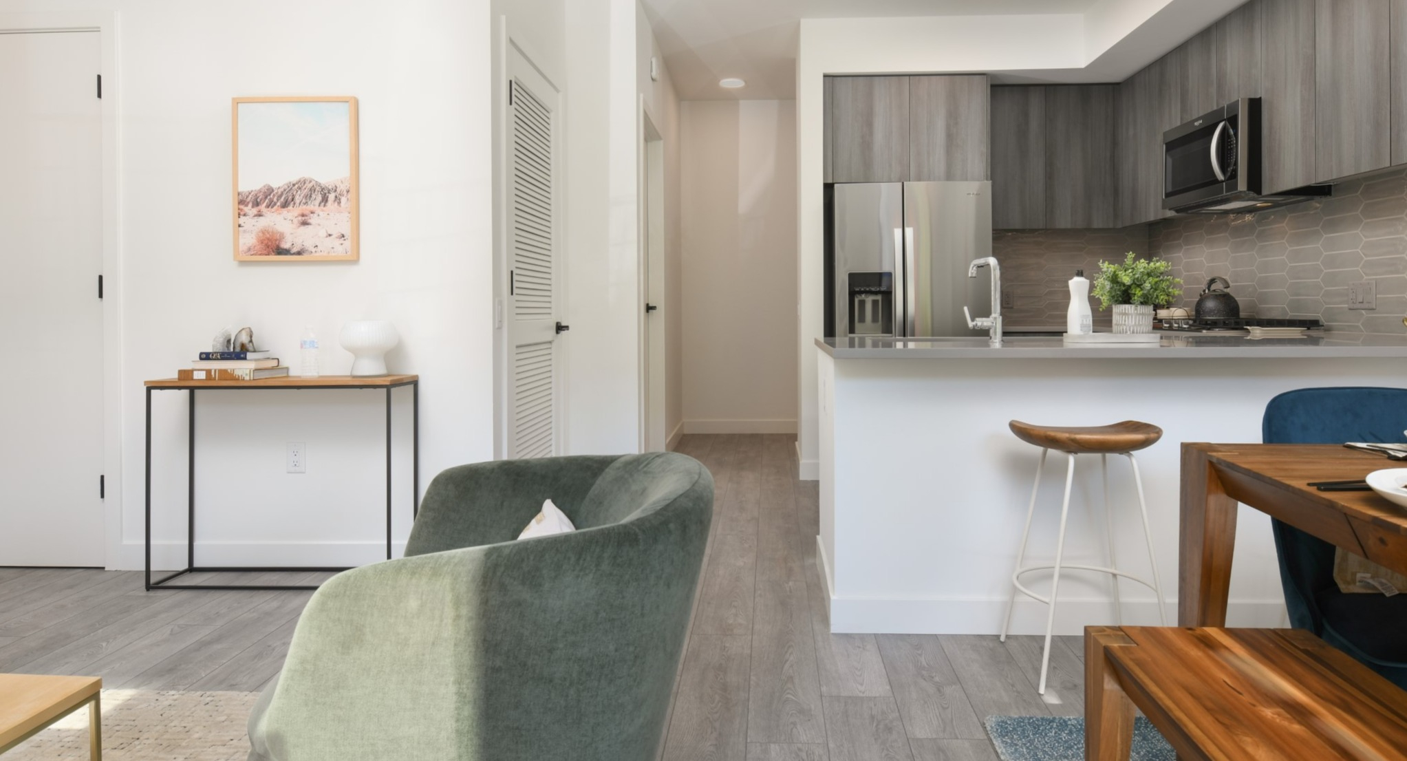 Spacious open-concept living area and kitchen at Porte Apartments Chicago, featuring modern finishes, dining space, and comfortable seating