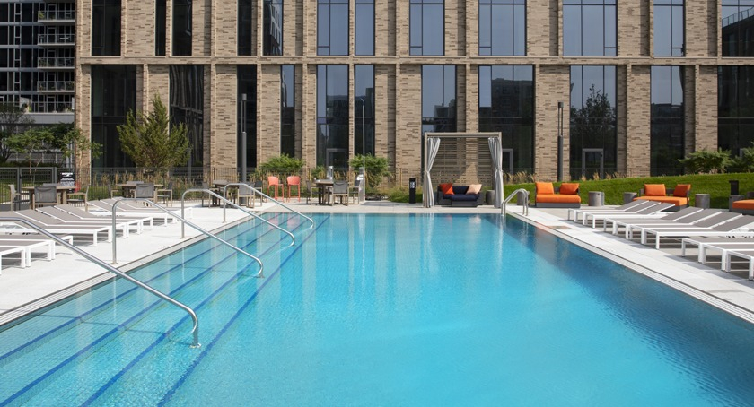 Resort-style outdoor pool area at Porte Apartments Chicago, surrounded by lounge chairs and offering a refreshing escape