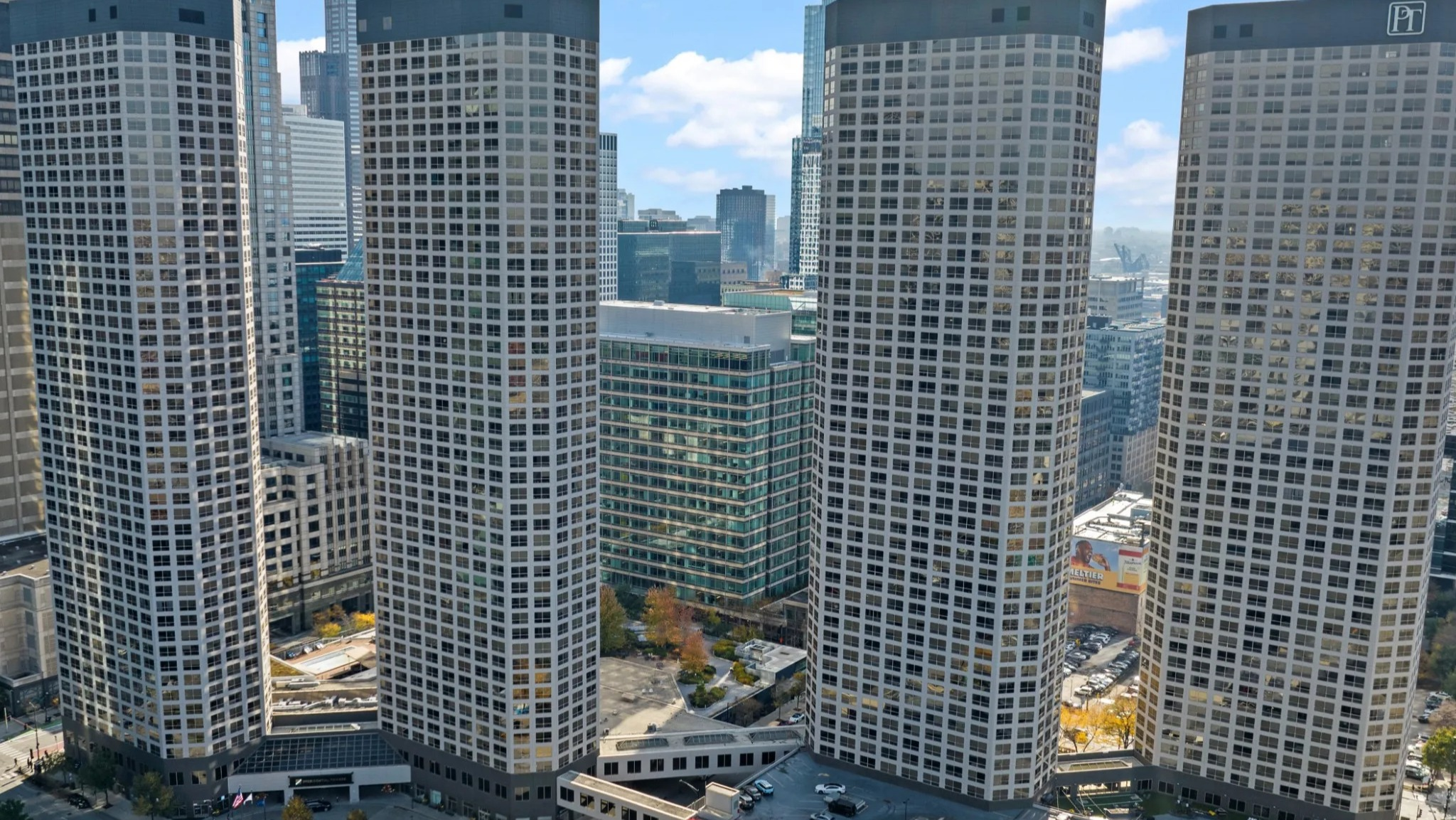 Aerial skyline view of Presidential Towers in Chicago showing four curved high-rise buildings and the surrounding West Loop neighborhood streets