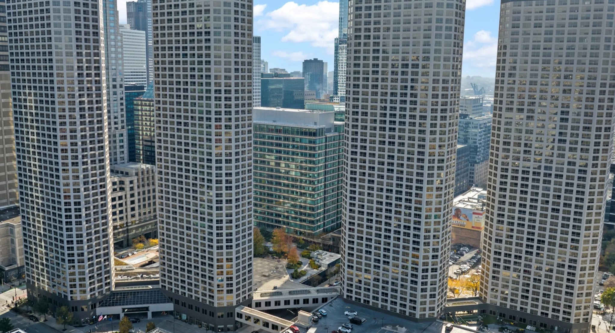 Aerial skyline view of Presidential Towers in Chicago showing four curved high-rise buildings and the surrounding West Loop neighborhood streets