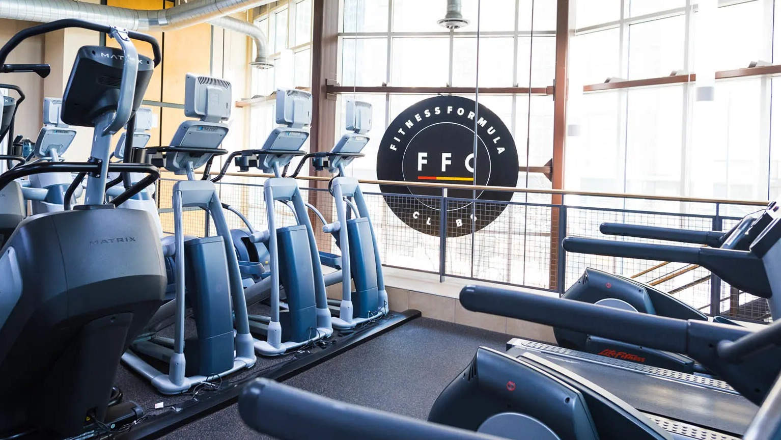 Cardio studio with treadmills and ellipticals in a light-filled gym at Presidential Towers apartments near downtown Chicago