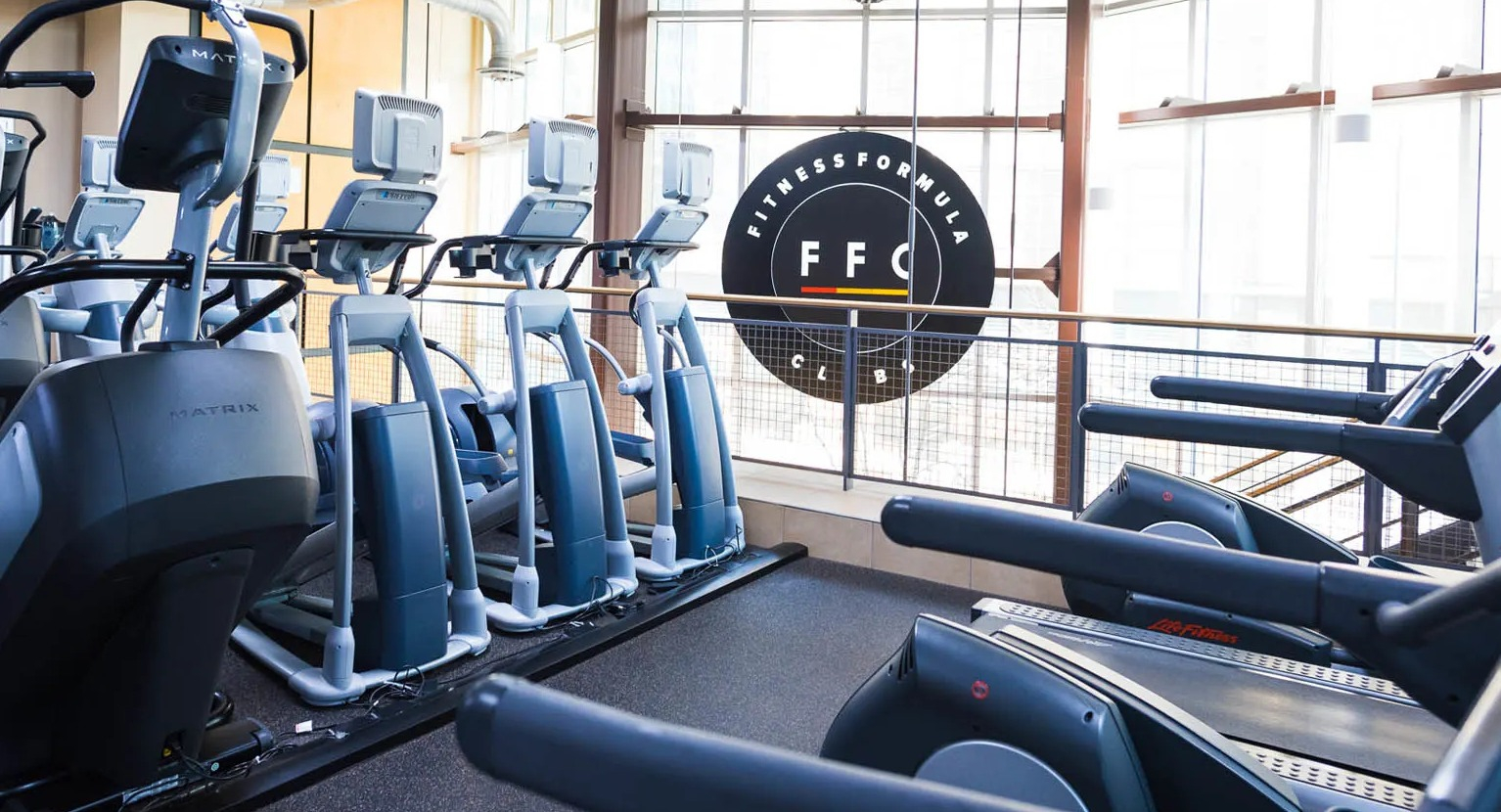Cardio studio with treadmills and ellipticals in a light-filled gym at Presidential Towers apartments near downtown Chicago