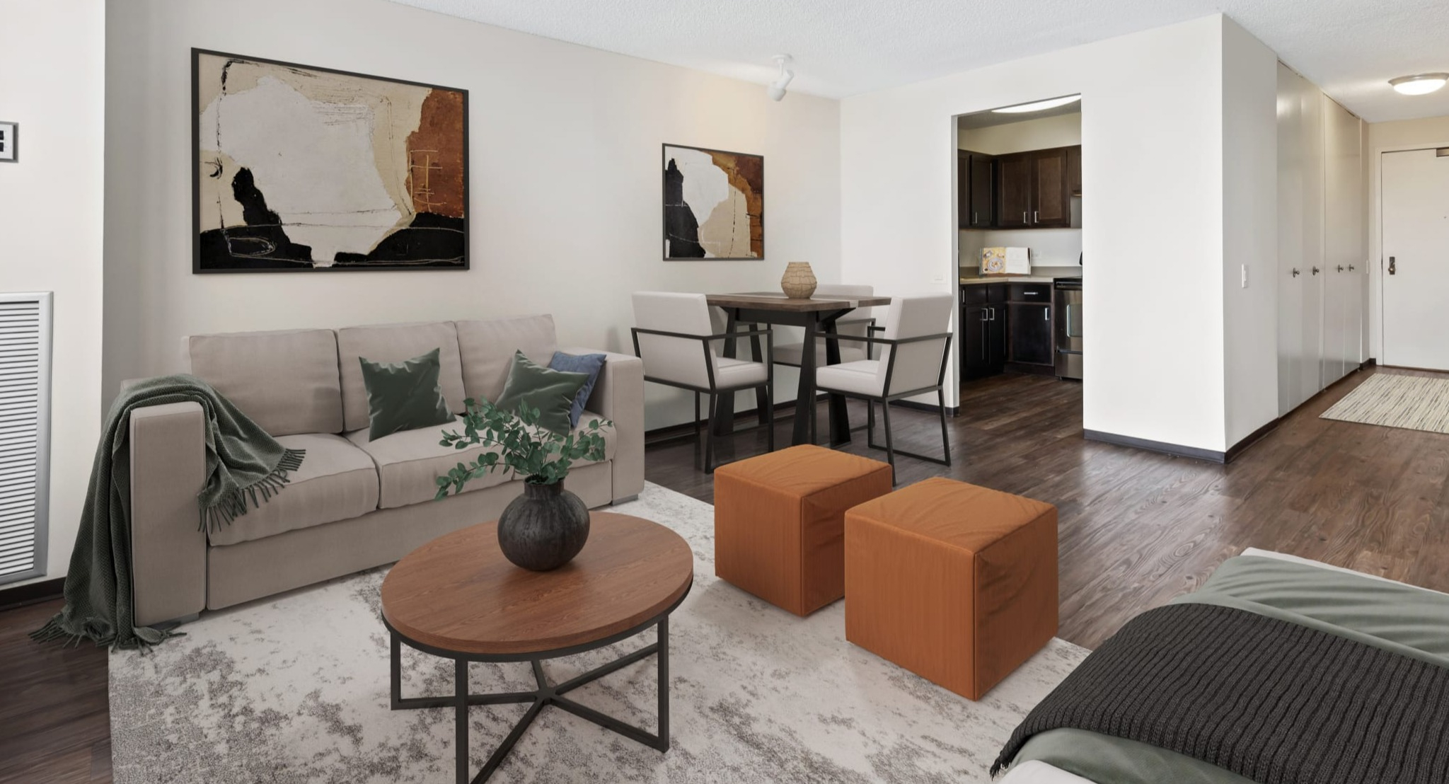 Open-concept living room with dining area and sightline to the kitchen, wood-style floors, and neutral decor at Presidential Towers Chicago