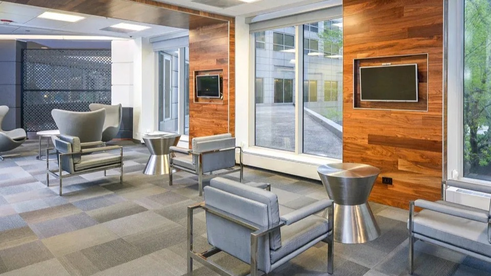 Comfortable resident lounge with contemporary seating, wood accents, and large windows at Presidential Towers apartments in Chicago