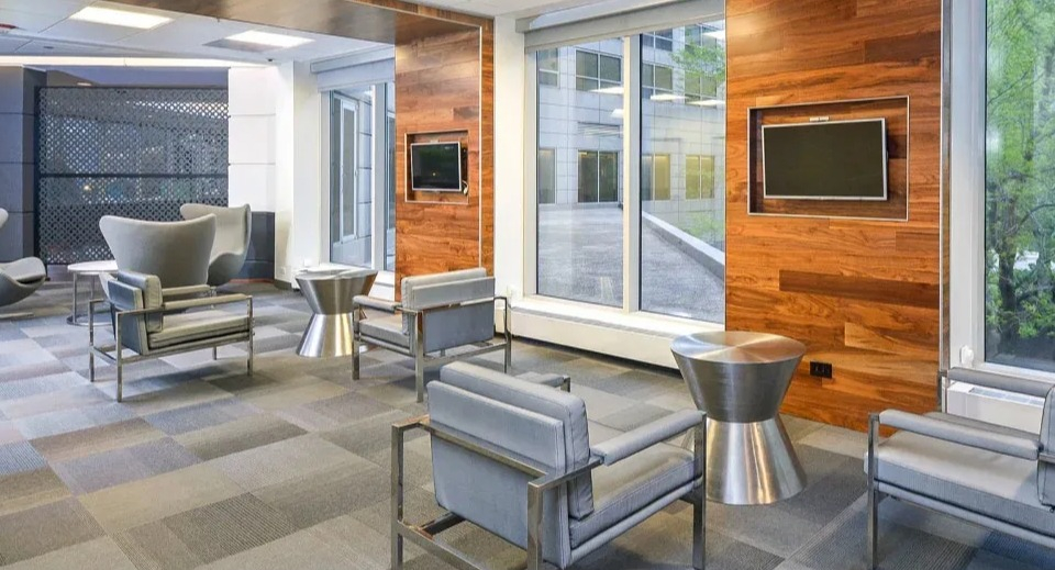 Comfortable resident lounge with contemporary seating, wood accents, and large windows at Presidential Towers apartments in Chicago