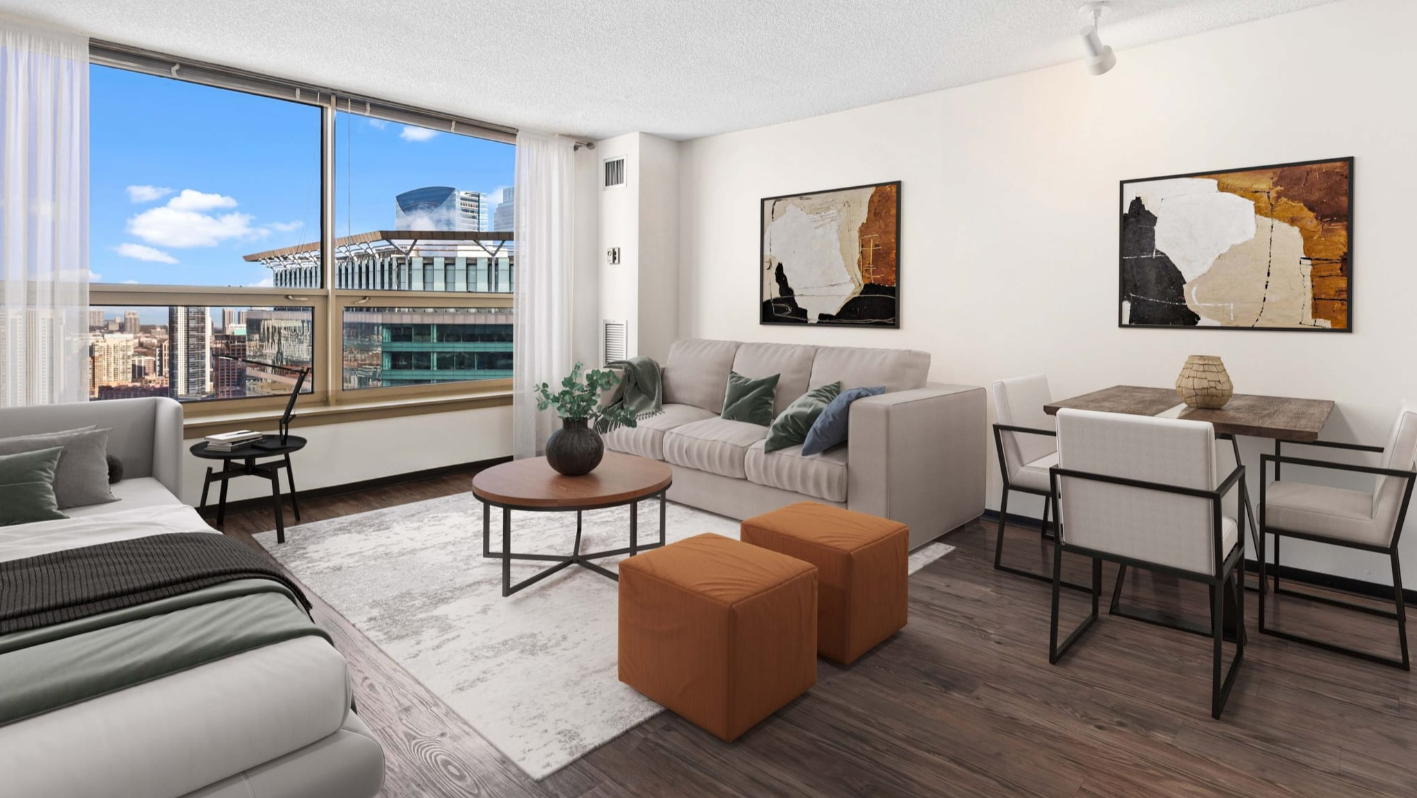Spacious studio layout with bed, sofa seating, dining set, large window, and wood-style floors at Presidential Towers in Chicago