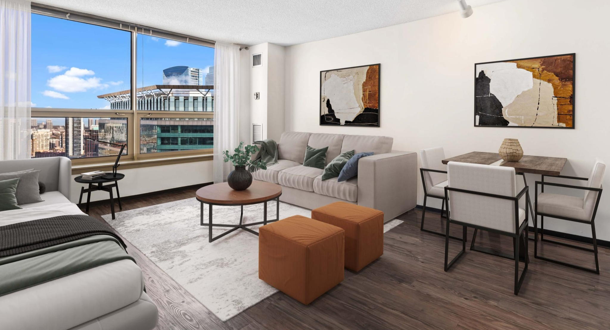 Spacious studio layout with bed, sofa seating, dining set, large window, and wood-style floors at Presidential Towers in Chicago
