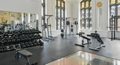 Expansive gym at Randolph Tower City Apartments in Chicago, featuring a wide range of free weights and strength training equipment