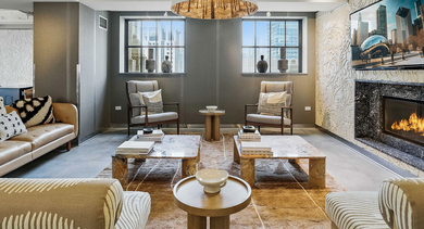 Chic lounge area at Randolph Tower City Apartments in Chicago, featuring a fireplace, various seating arrangements, and a large TV