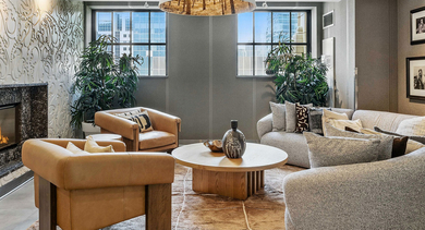 Elegant resident lounge at Randolph Tower City Apartments in Chicago, featuring comfortable seating, a modern fireplace, and stylish decor