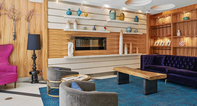Vibrant resident lounge at Randolph Tower City Apartments in Chicago, featuring colorful furniture, unique decor, and a large TV