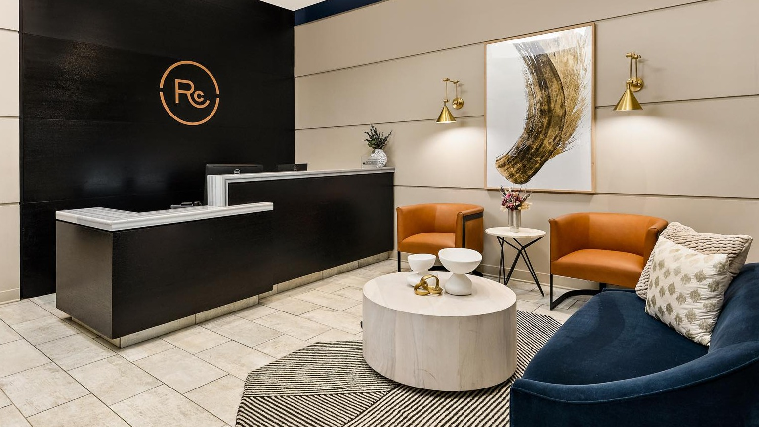 Grand entrance lobby featuring a modern reception desk, luxurious seating, and sophisticated decor elements at Roosevelt Collection Lofts