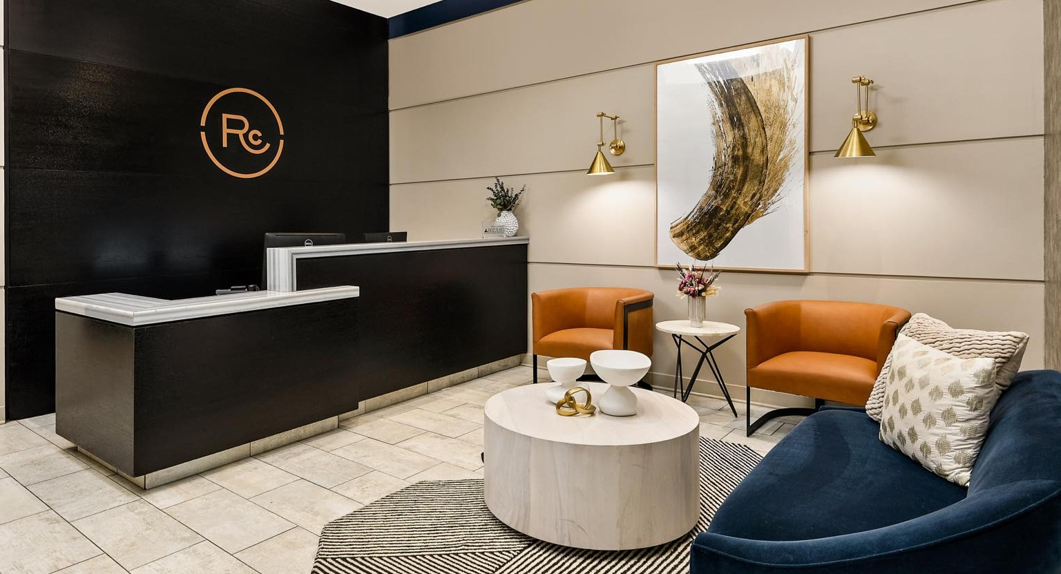 Grand entrance lobby featuring a modern reception desk, luxurious seating, and sophisticated decor elements at Roosevelt Collection Lofts