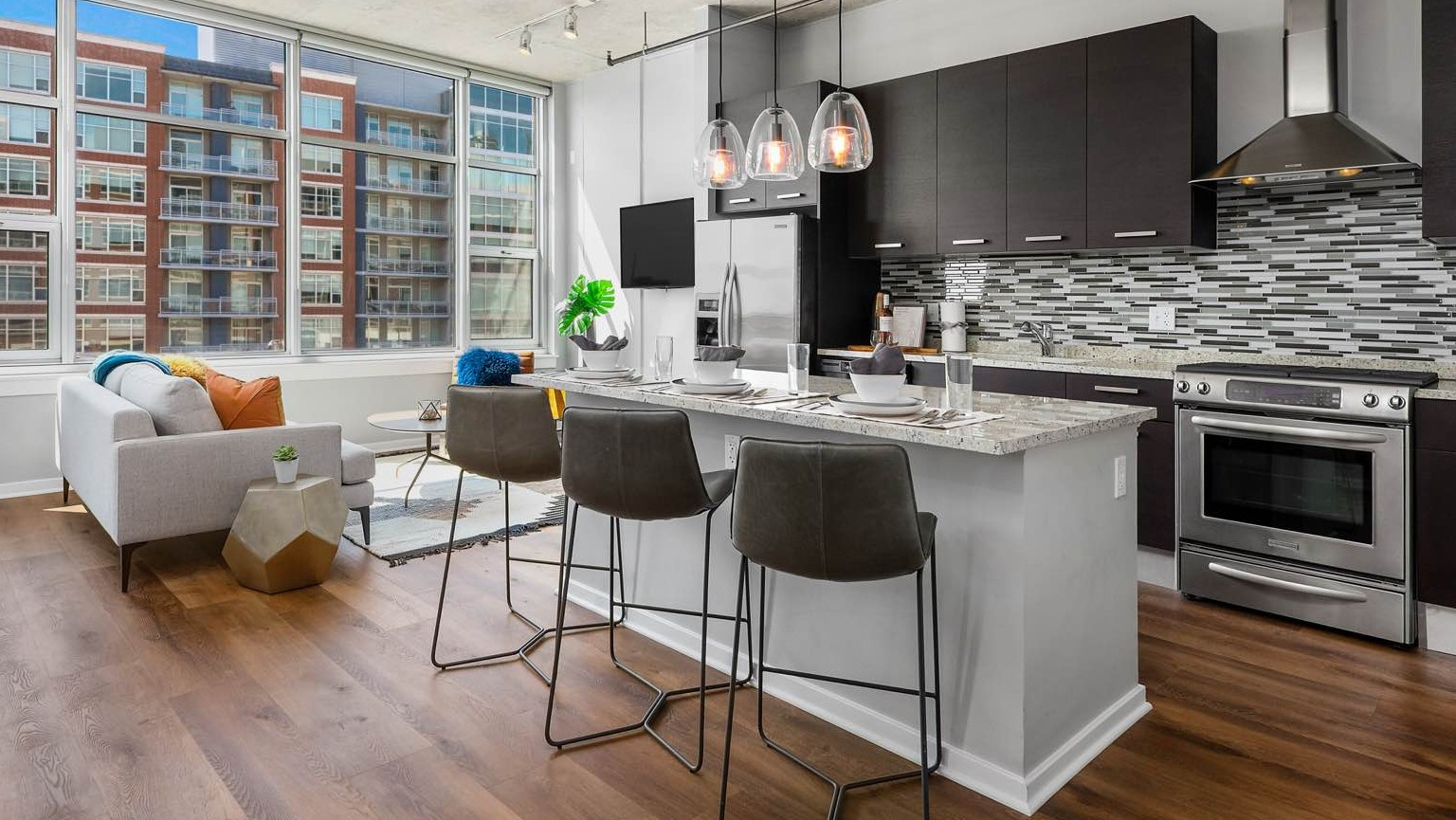 Bright apartment at Roosevelt Collection Lofts in Chicago, featuring a modern kitchen with an island, and a comfortable living area with large windows