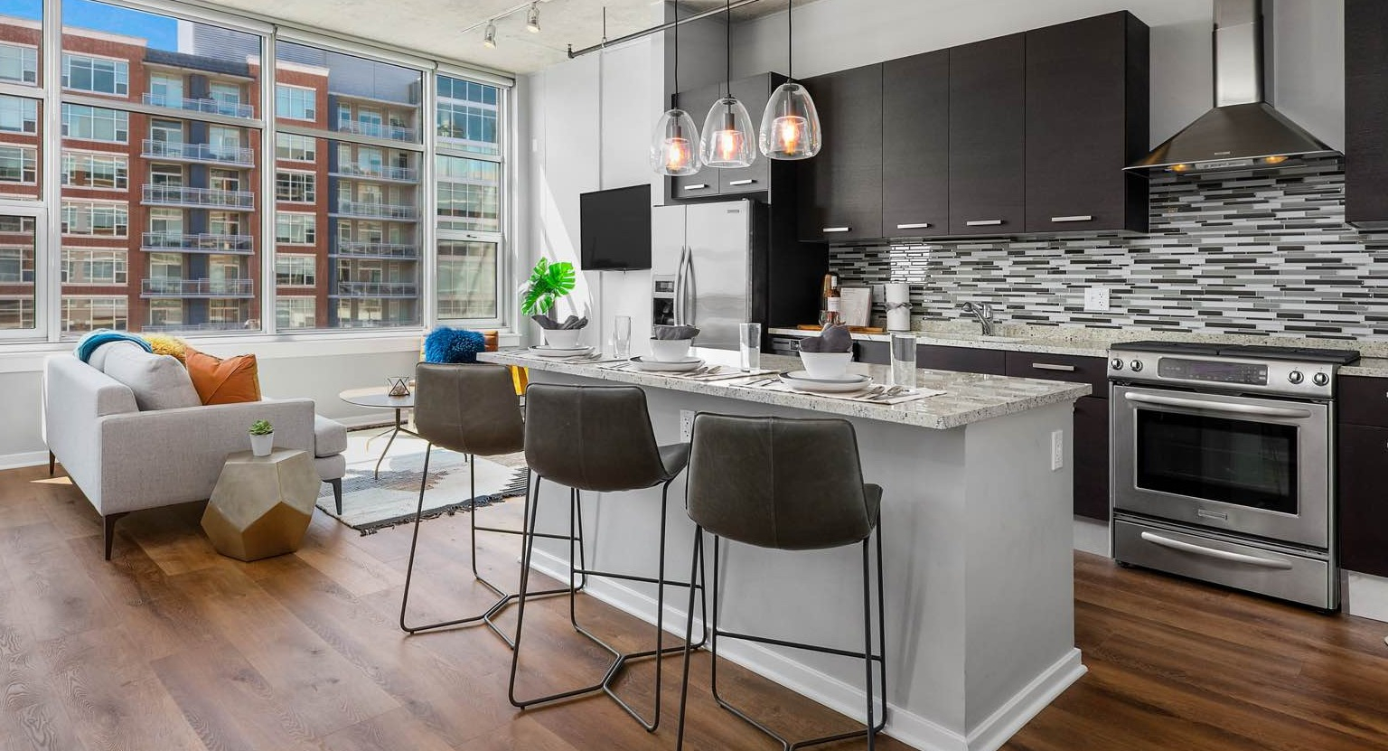 Bright apartment at Roosevelt Collection Lofts in Chicago, featuring a modern kitchen with an island, and a comfortable living area with large windows