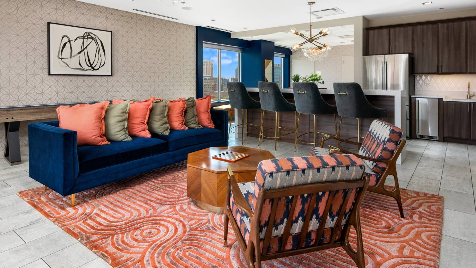 Lively resident lounge with a bar area, comfortable sofas, a shuffleboard table, and vibrant decor at Roosevelt Collection Lofts