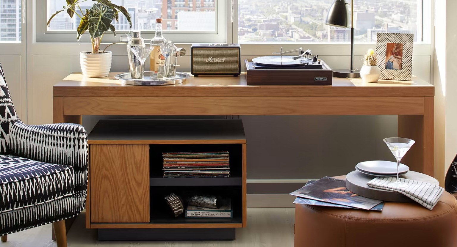 Chic entertainment area at Sentral Michigan Avenue in Chicago, featuring an armchair, record player, and a guitar, with city views
