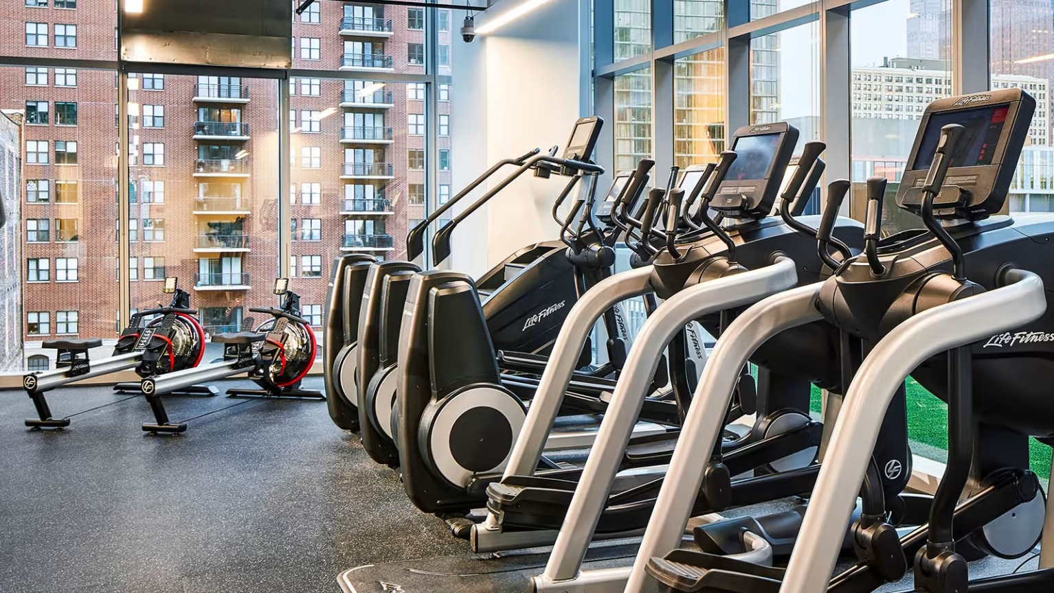 State-of-the-art fitness center at Sentral Michigan Avenue in Chicago, featuring a wide range of cardio machines and expansive city views