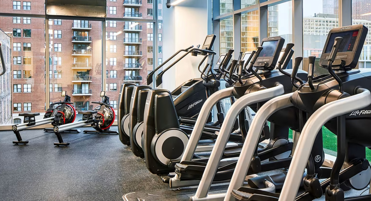 State-of-the-art fitness center at Sentral Michigan Avenue in Chicago, featuring a wide range of cardio machines and expansive city views