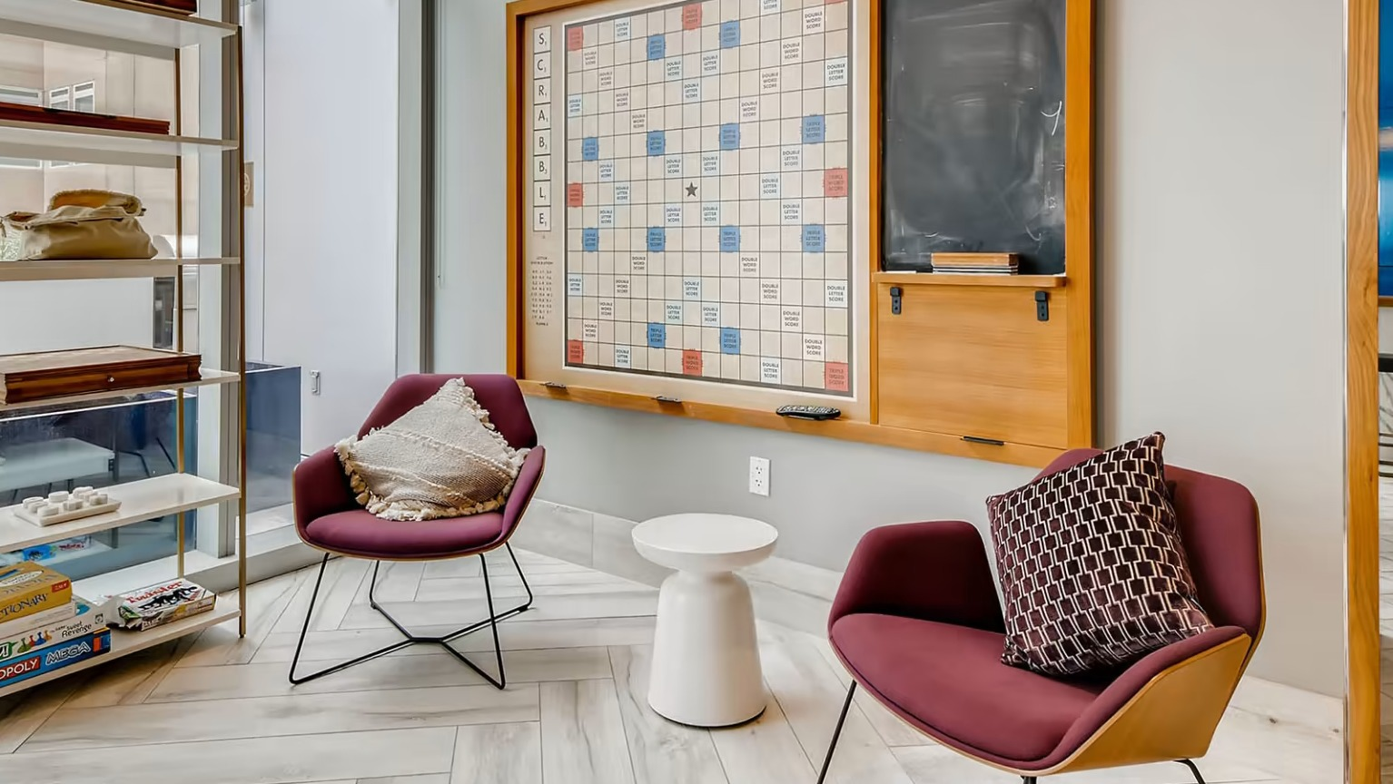Fun game room at Sentral Michigan Avenue in Chicago, featuring a large wall-mounted Scrabble board and comfortable seating