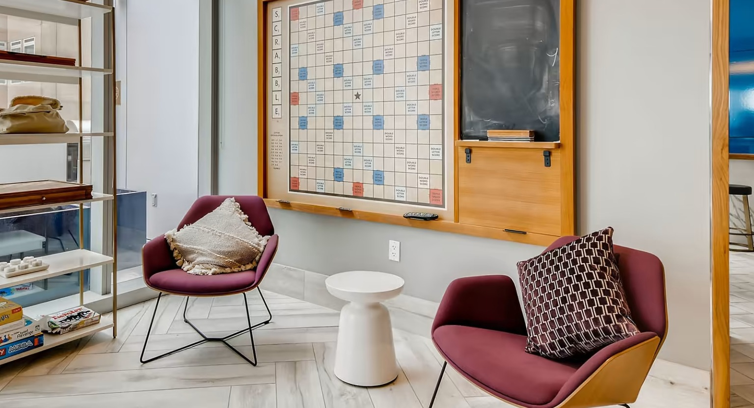 Fun game room at Sentral Michigan Avenue in Chicago, featuring a large wall-mounted Scrabble board and comfortable seating