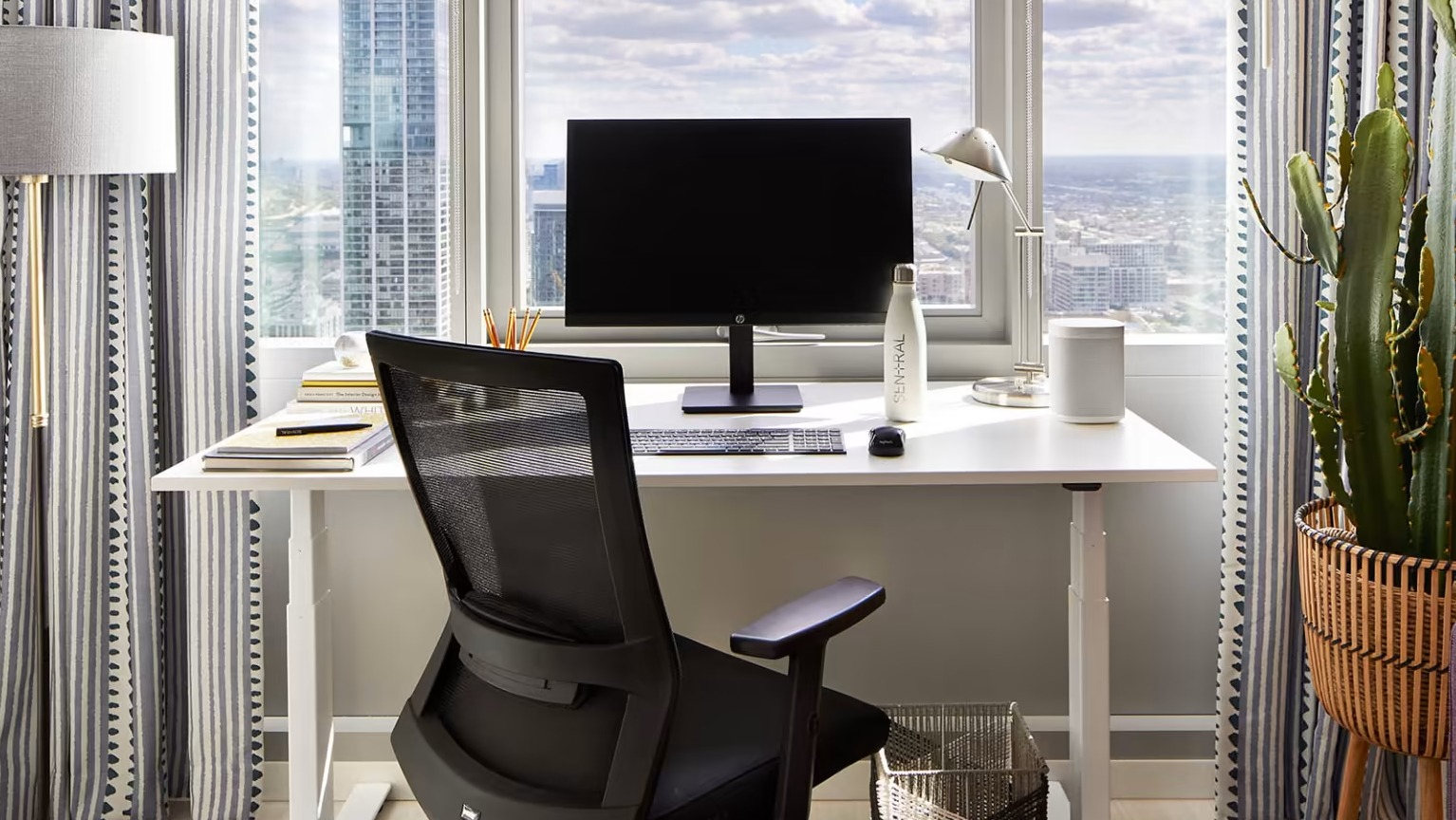 Dedicated home office space at Sentral Michigan Avenue in Chicago, featuring a modern desk, ergonomic chair, and inspiring city views