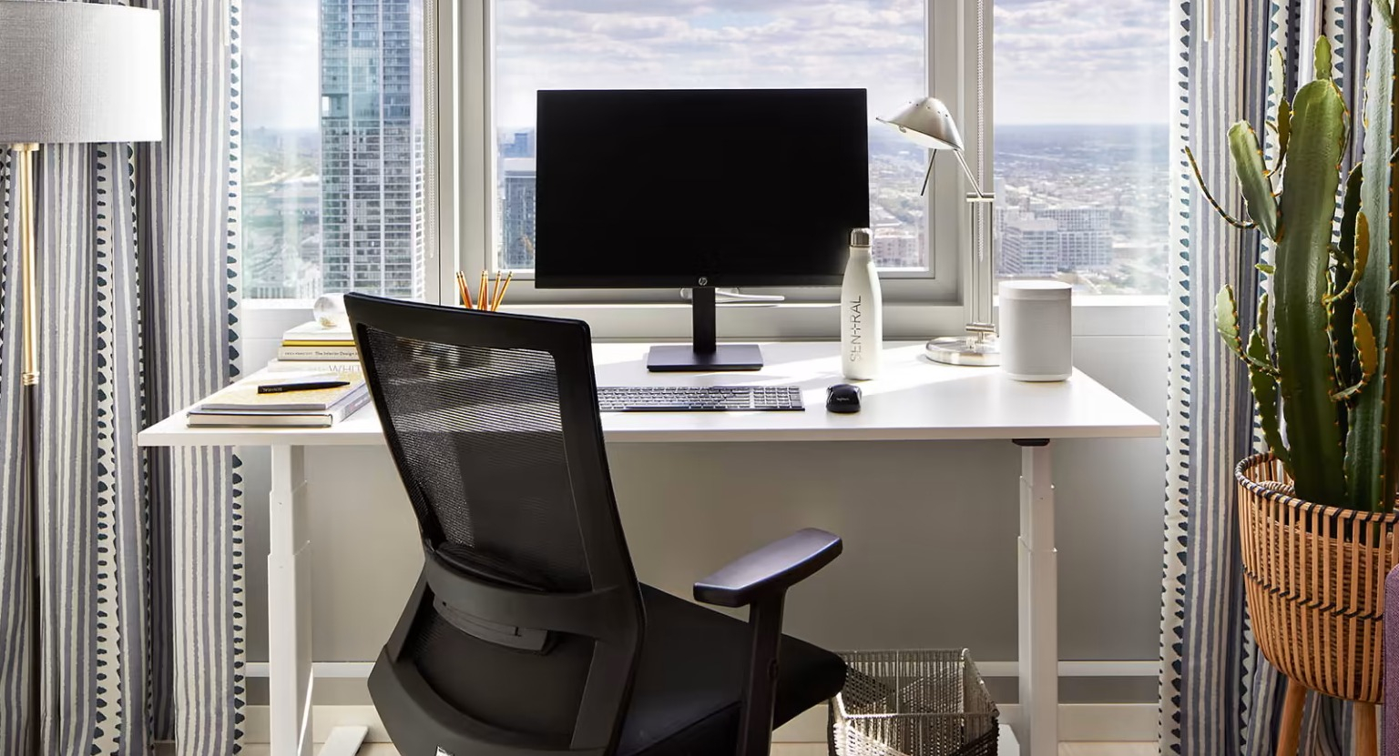 Dedicated home office space at Sentral Michigan Avenue in Chicago, featuring a modern desk, ergonomic chair, and inspiring city views