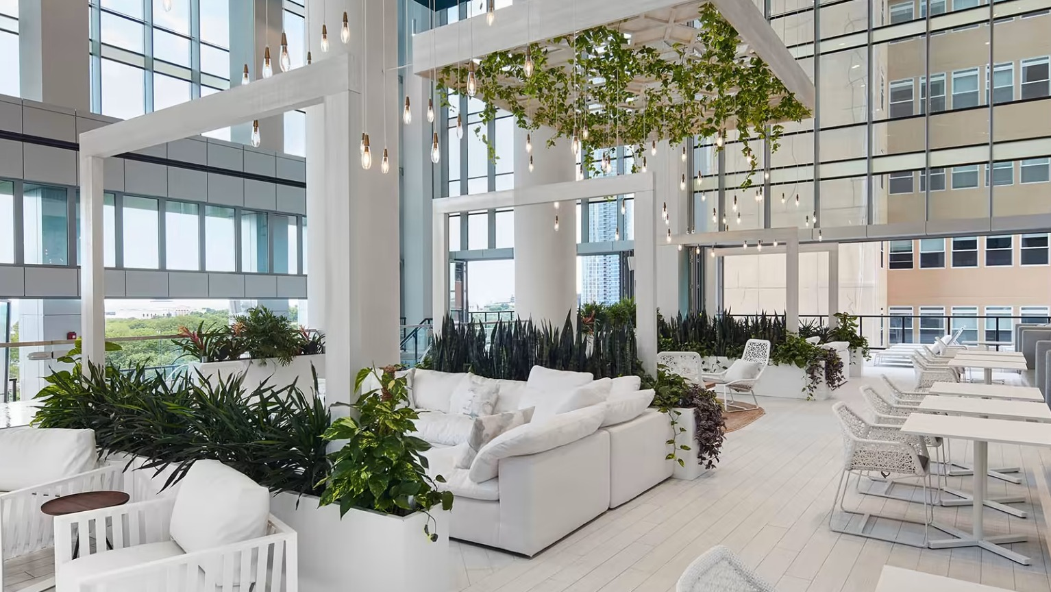 Expansive resident lounge at Sentral Michigan Avenue in Chicago, featuring lush indoor gardens, comfortable seating, and abundant natural light
