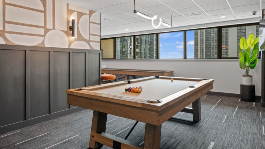 Resident game room at Shoreham and Tides in Chicago with billiards table, lounge seating, and city views for relaxed, social downtime
