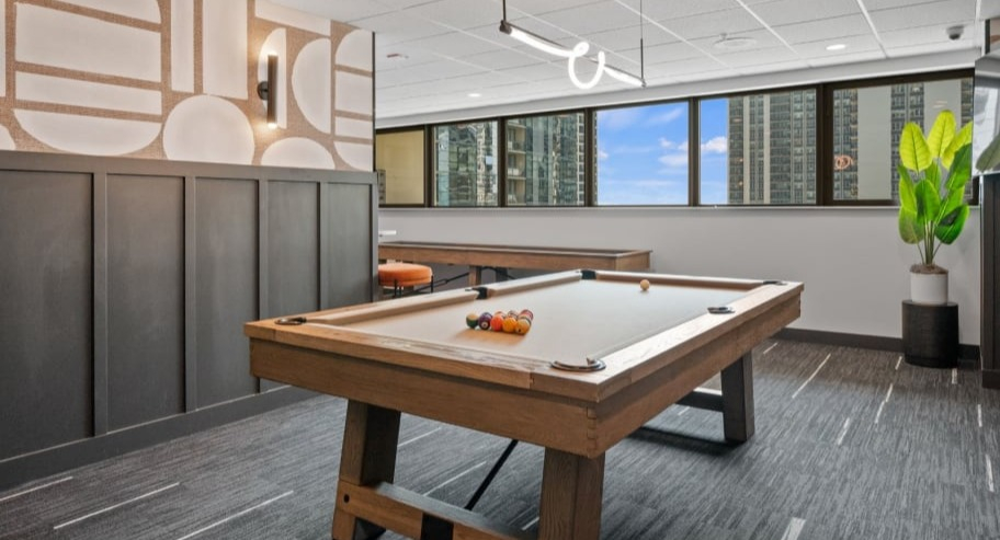 Resident game room at Shoreham and Tides in Chicago with billiards table, lounge seating, and city views for relaxed, social downtime