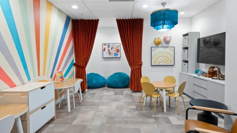 Colorful kids’ playroom at Shoreham and Tides in Chicago with artful wall design, play tables, bean bags, and storage for family-friendly living