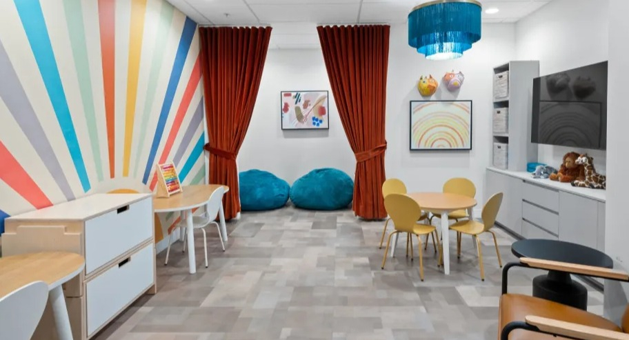 Colorful kids’ playroom at Shoreham and Tides in Chicago with artful wall design, play tables, bean bags, and storage for family-friendly living