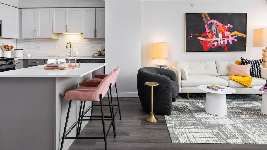 Open-concept layout at Shoreham and Tides apartments in Chicago, combining a modern kitchen with island seating and a bright living area