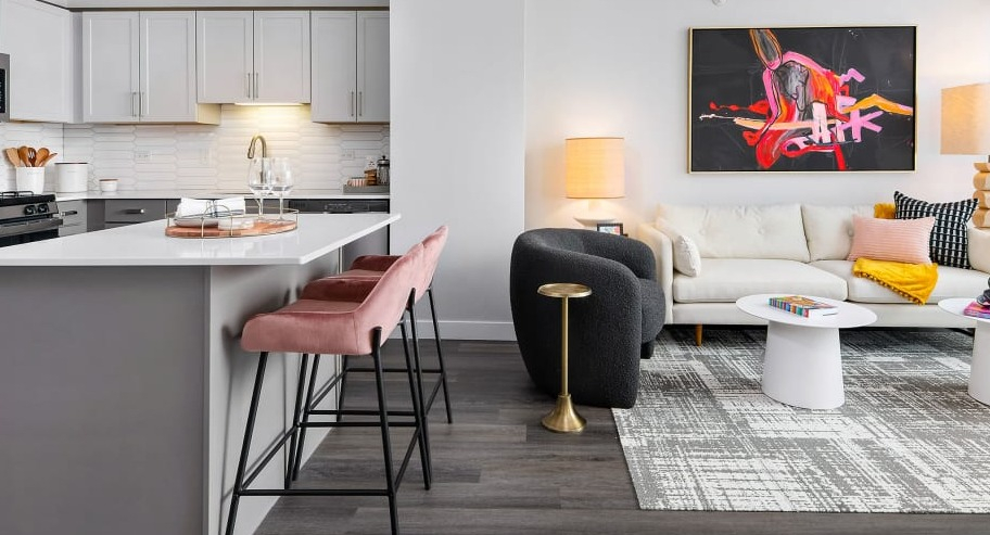 Open-concept layout at Shoreham and Tides apartments in Chicago, combining a modern kitchen with island seating and a bright living area