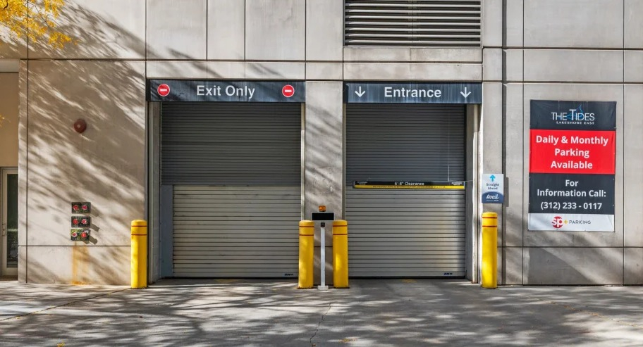 Secure parking garage entrance and exit with signage at Shoreham and Tides apartments in Chicago
