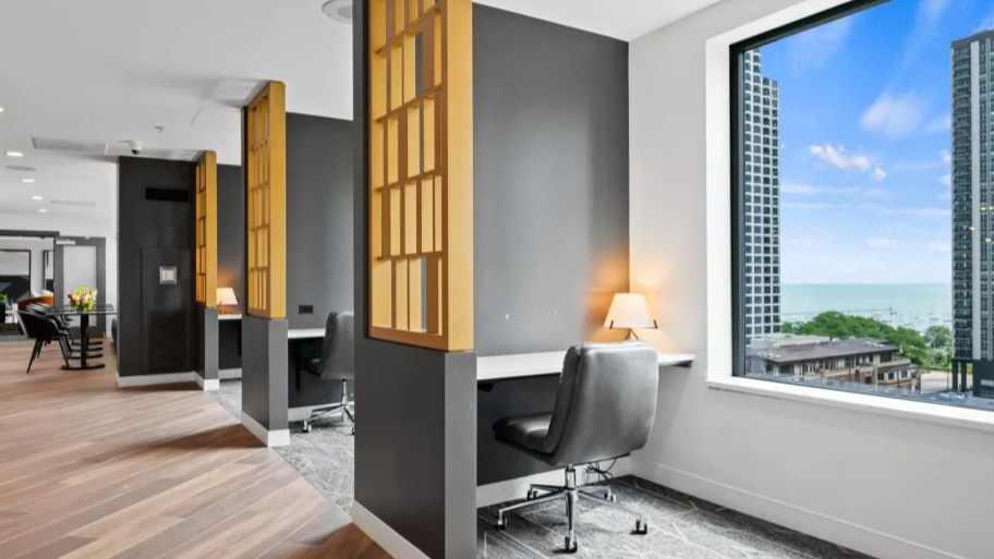 Quiet work-from-home nooks at Shoreham and Tides apartments in Chicago with built-in desks, privacy screens, and a lake view from large window