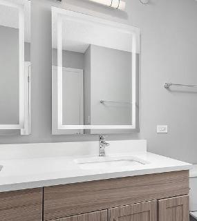 Bathroom with dual vanity and modern fixtures at Shoreham and Tides apartments in Chicago