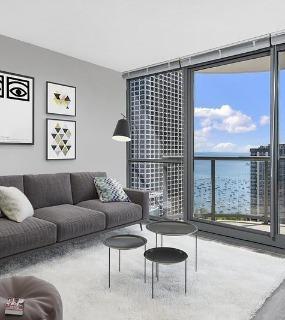 Living room with a stunning lake view at Shoreham and Tides apartments in Chicago