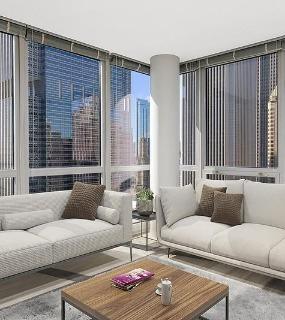 Living room with floor-to-ceiling windows and city skyline views at Shoreham and Tides apartments in Chicago
