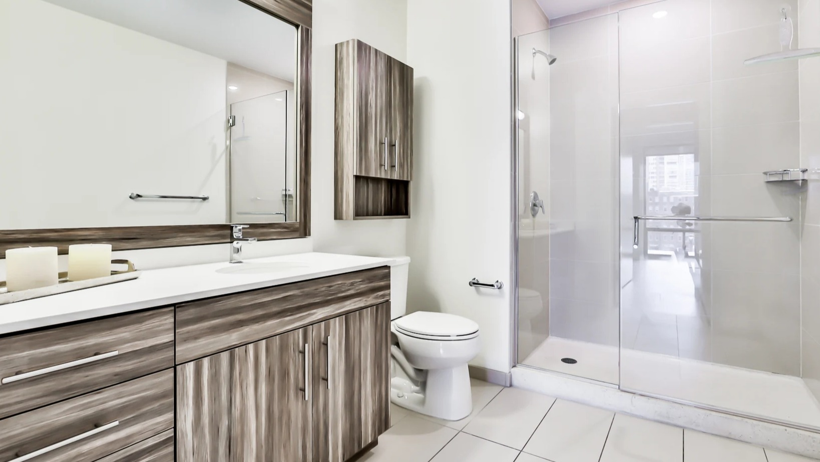 Modern bathroom at Sienna in Chicago, featuring a spacious walk-in shower with a glass enclosure and a stylish vanity