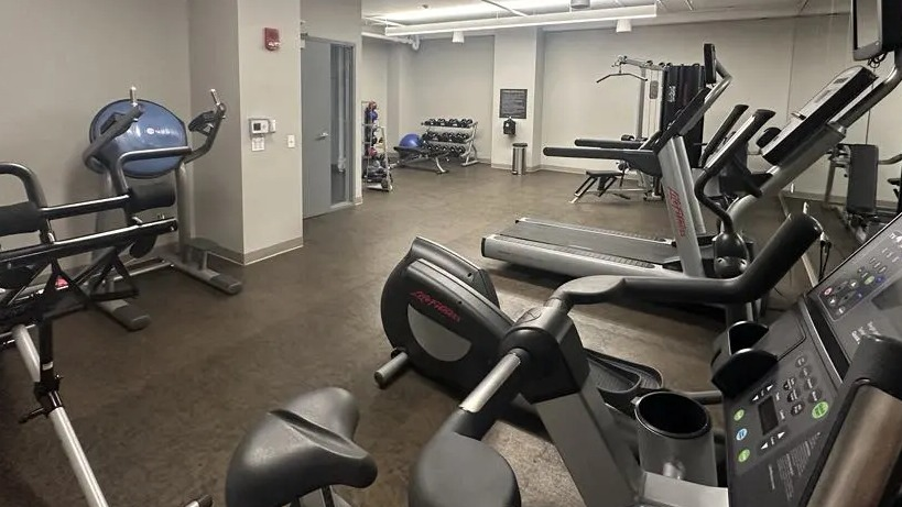 Well-equipped fitness center at Sienna in Chicago, featuring multiple treadmills, ellipticals, and strength training machines
