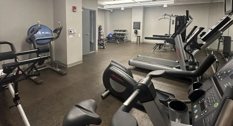 Well-equipped fitness center at Sienna in Chicago, featuring multiple treadmills, ellipticals, and strength training machines