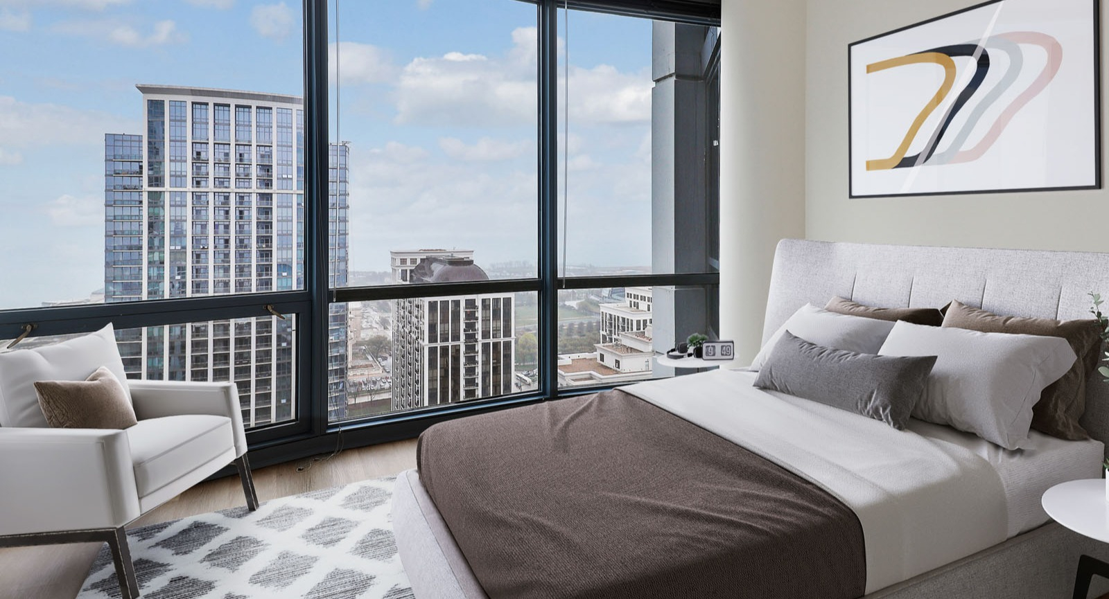 Bright bedroom at SKY55 in Chicago, featuring a cozy bed, armchair, and stunning panoramic city views through large windows