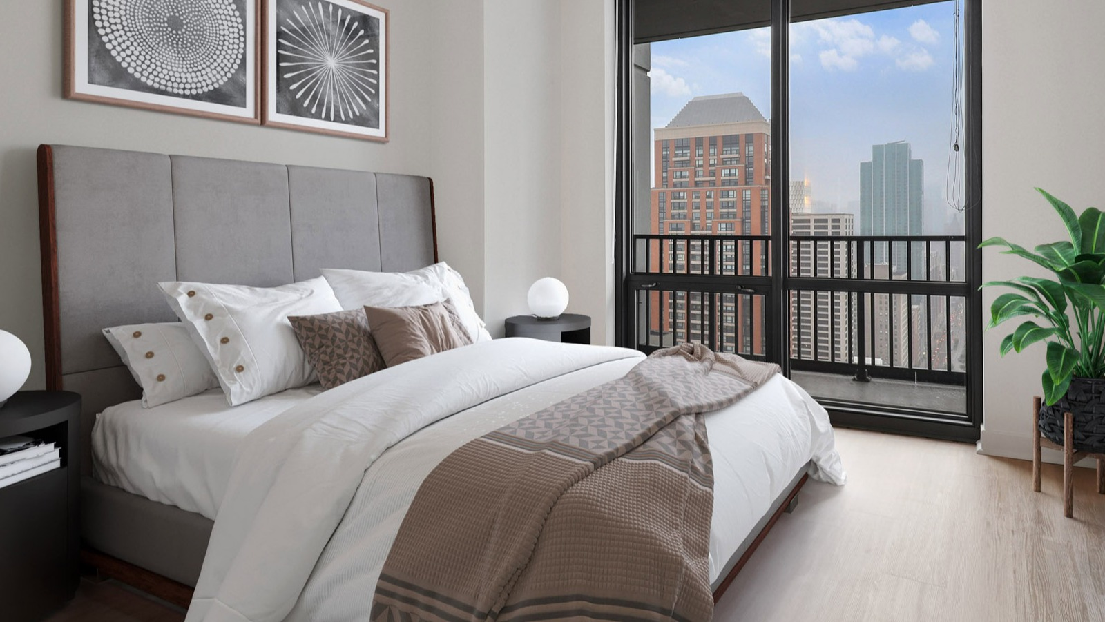 Inviting guest bedroom at SKY55 in Chicago, featuring a comfortable bed, stylish decor, and large windows with urban views